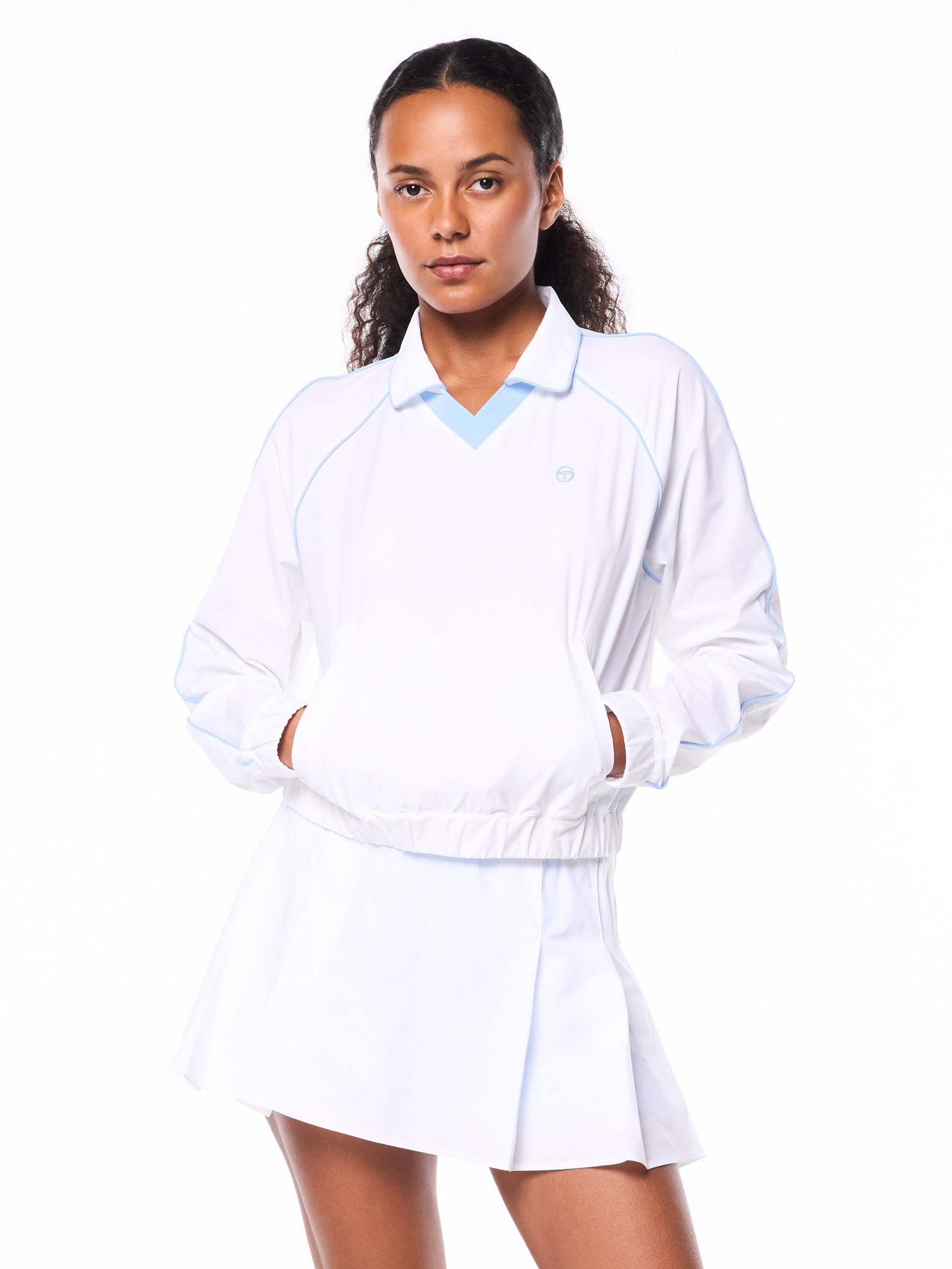 Woman wearing a white top with a blue collar on a white background