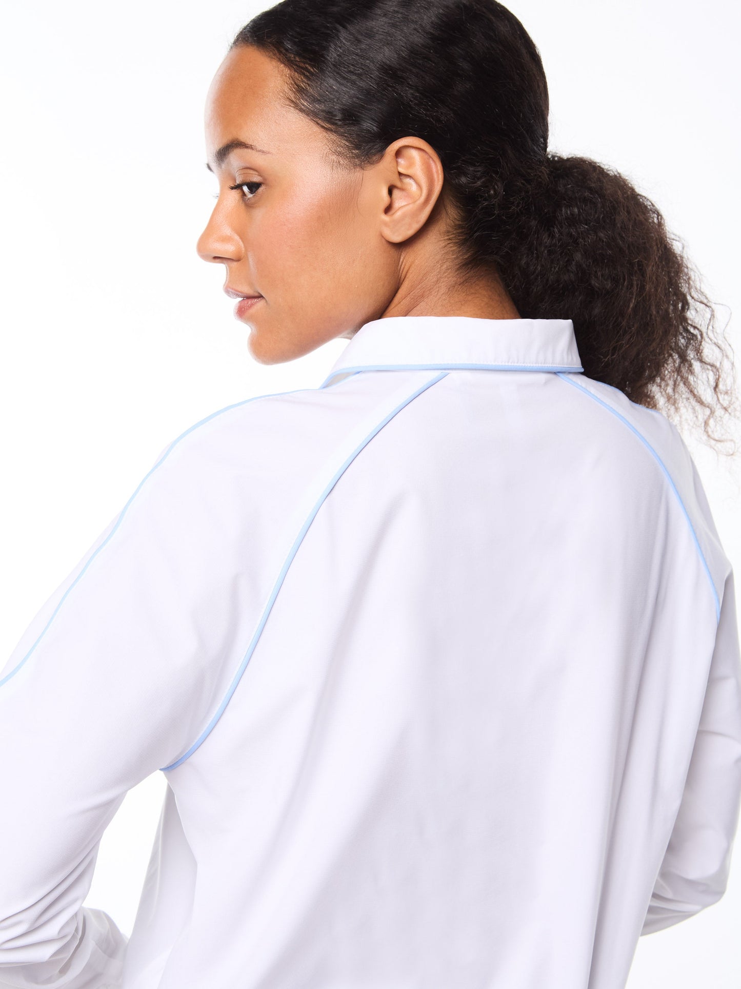 Woman wearing a white shirt with blue trim on a white background