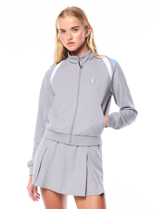 Woman wearing a gray tracksuit with a logo on a white background