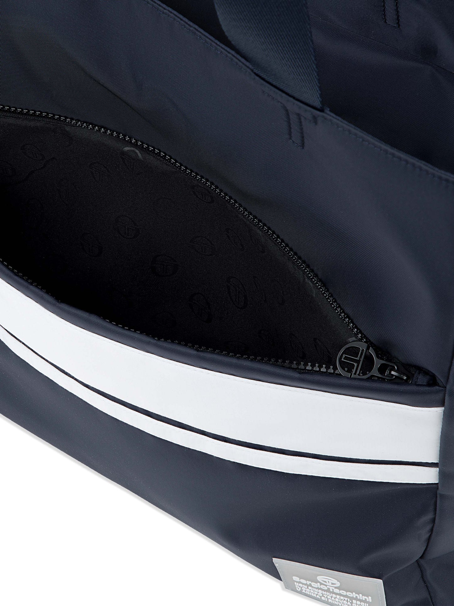 Close-up of a navy bag with white stripes and a visible brand label.