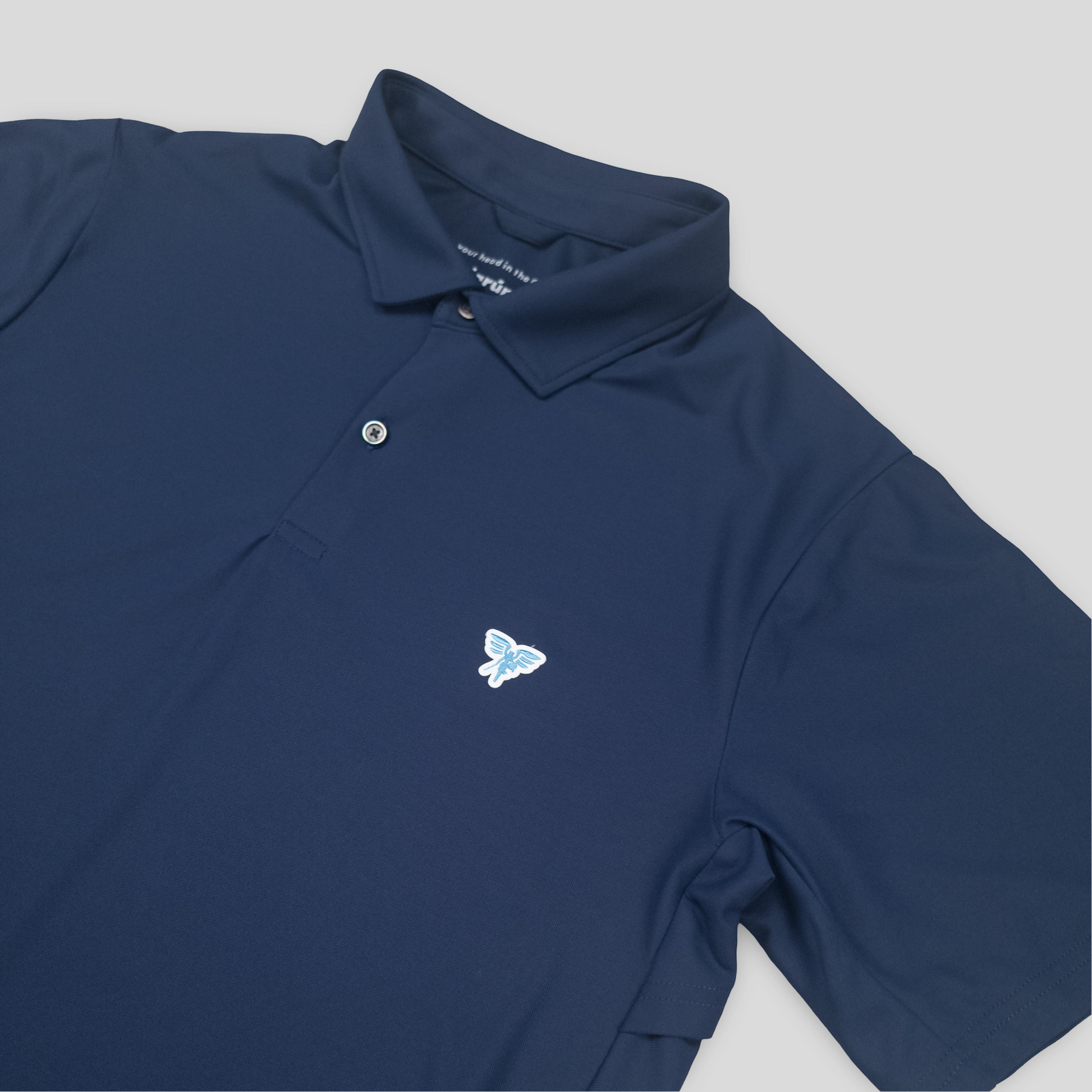 Navy blue polo shirt with a butterfly logo on a light gray background
