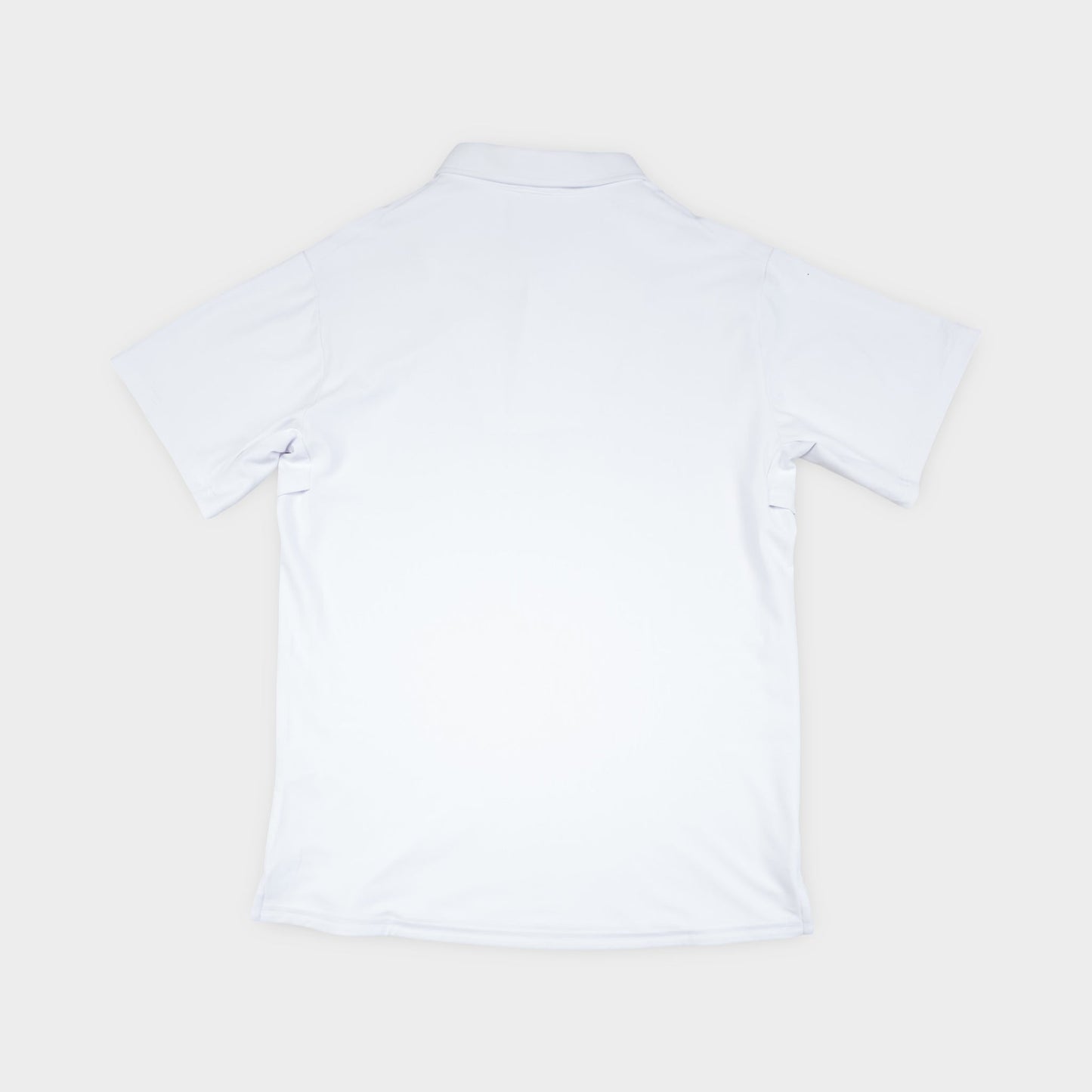 White polo shirt on a light beige background