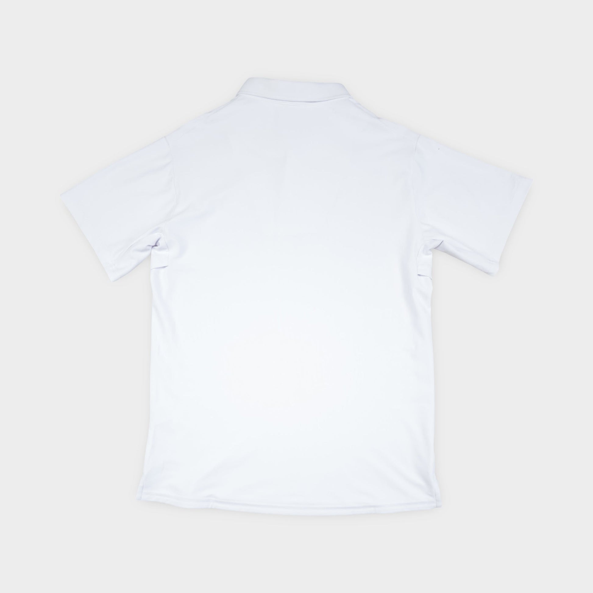 White polo shirt on a light beige background