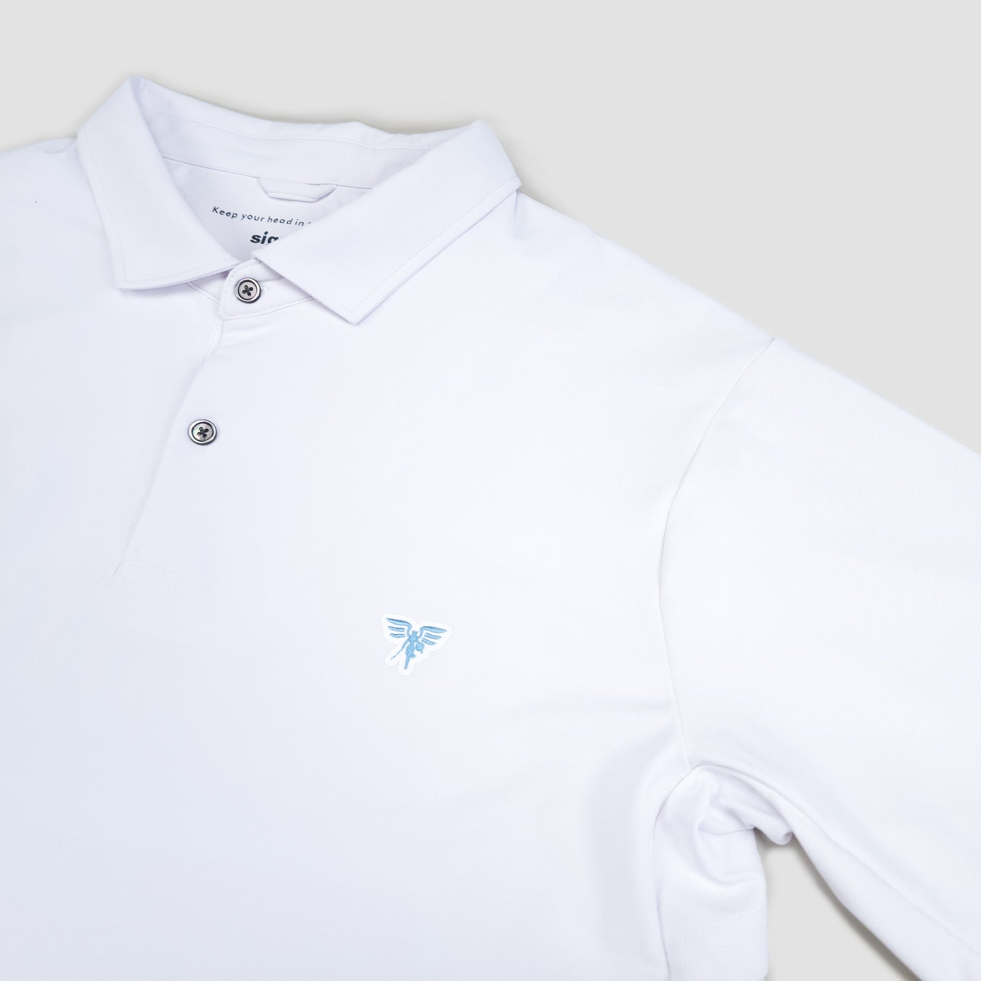 White polo shirt with a small blue logo on a light gray background