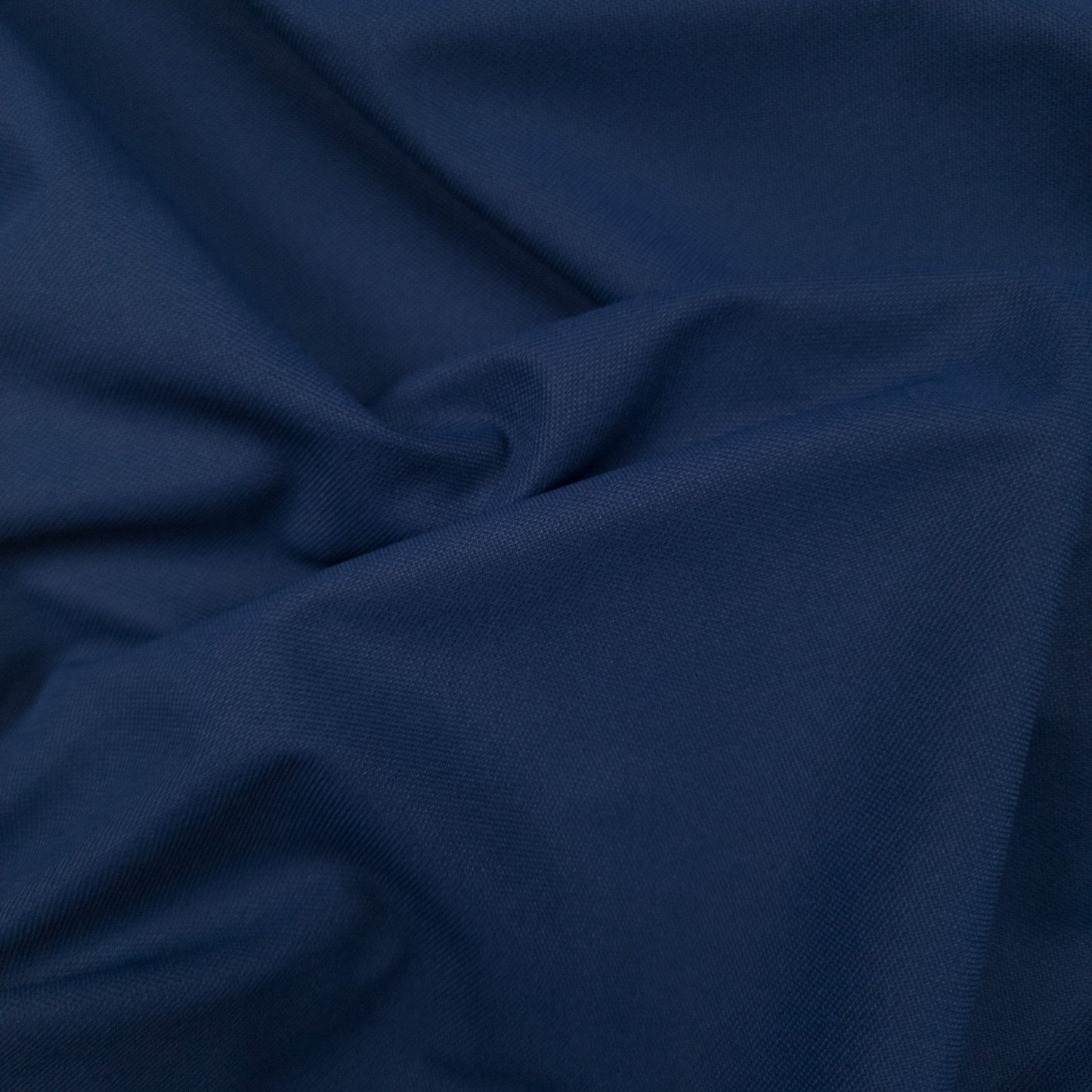 Close-up of dark blue fabric with folds