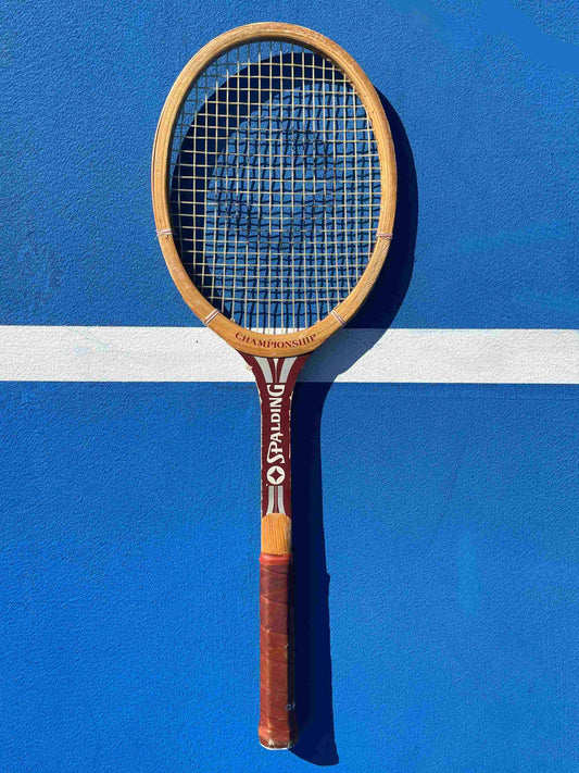 Spalding Vintage tennis racket on a blue court with white lines