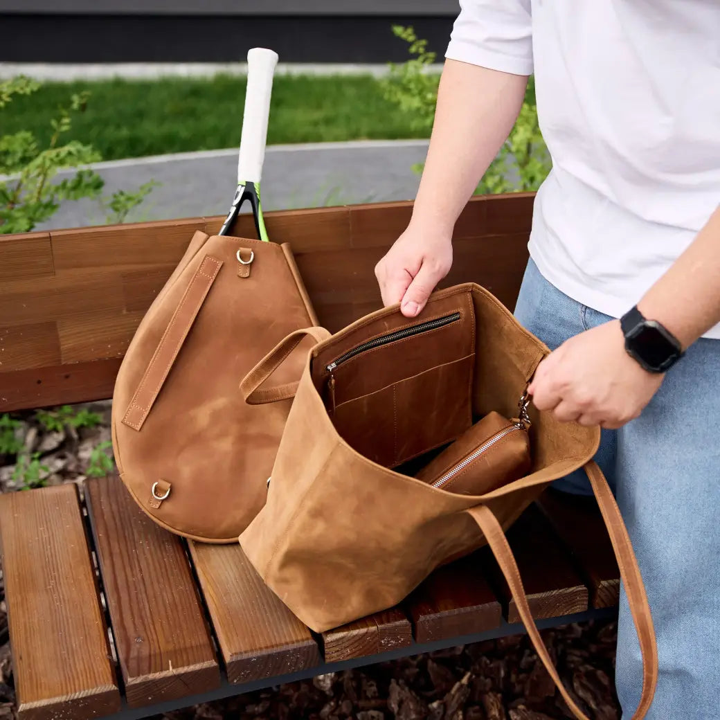 Genuine leather bag with removable tennis racket cover.
