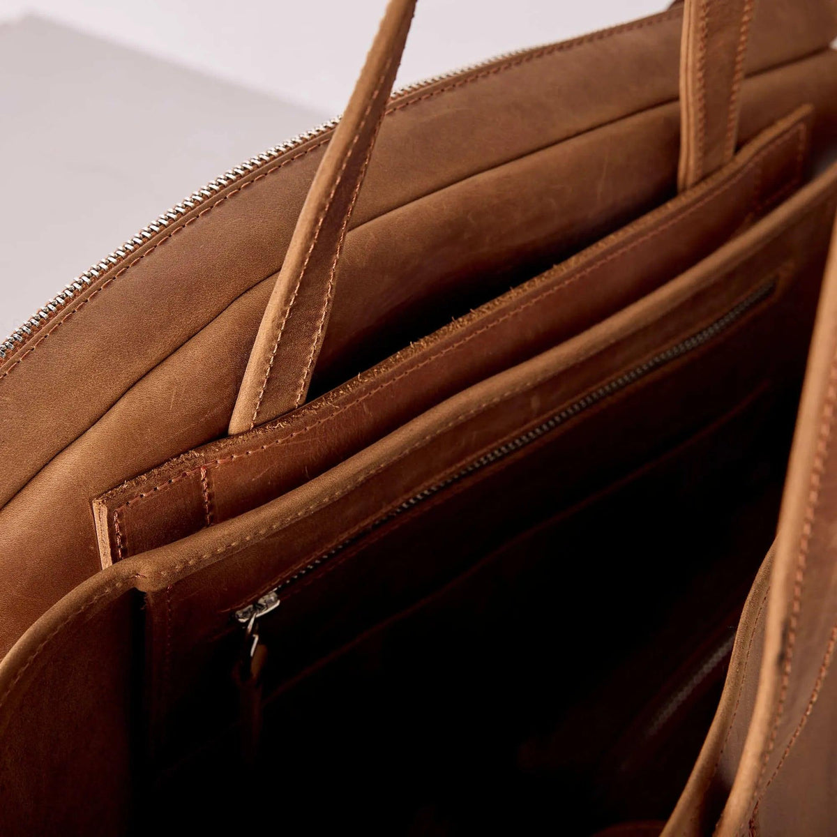Genuine leather bag with removable tennis racket cover.