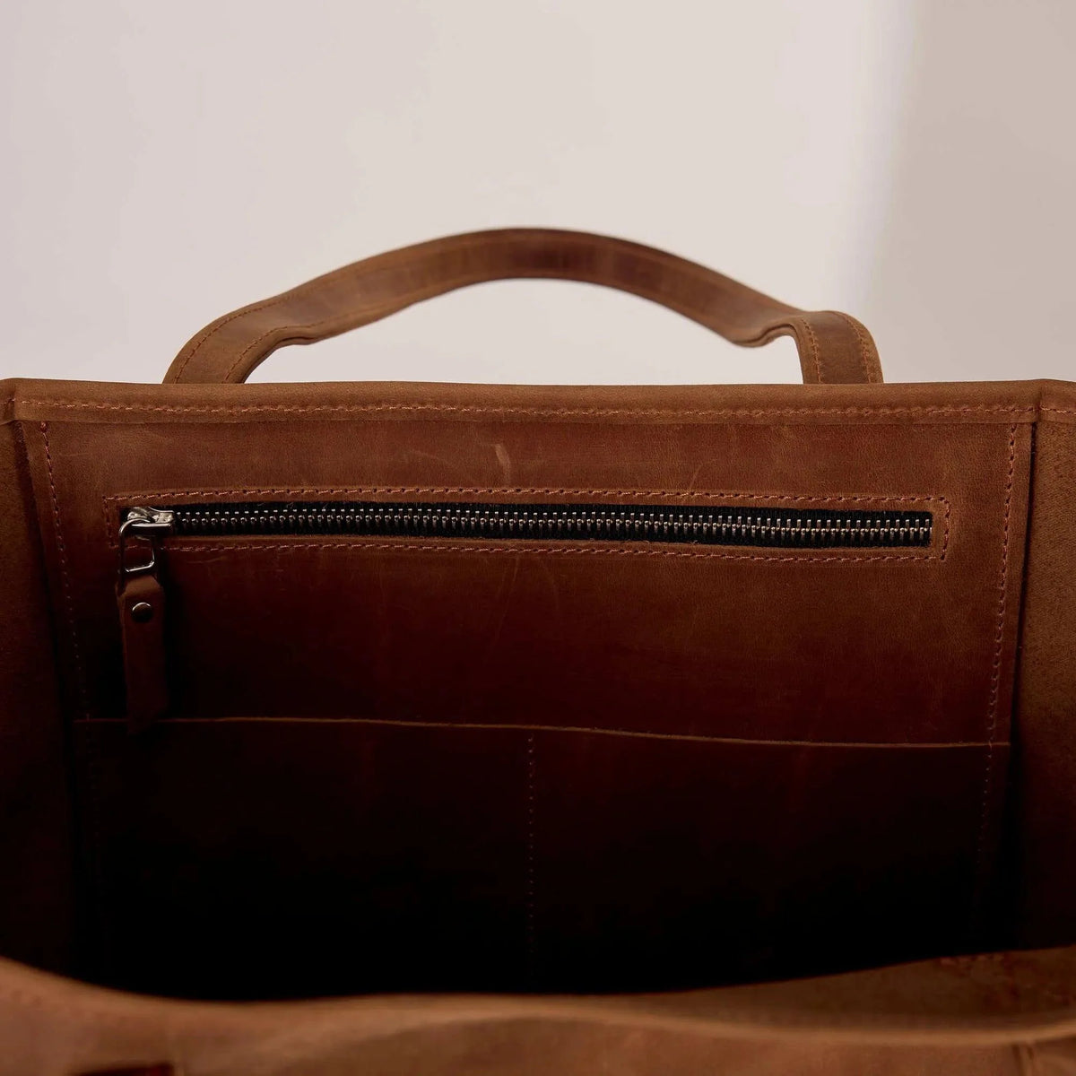 Genuine leather bag with removable tennis racket cover.