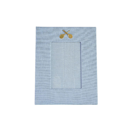 Light blue linen picture with gold medallion of crossed tennis racquets on Tennis DuJour.