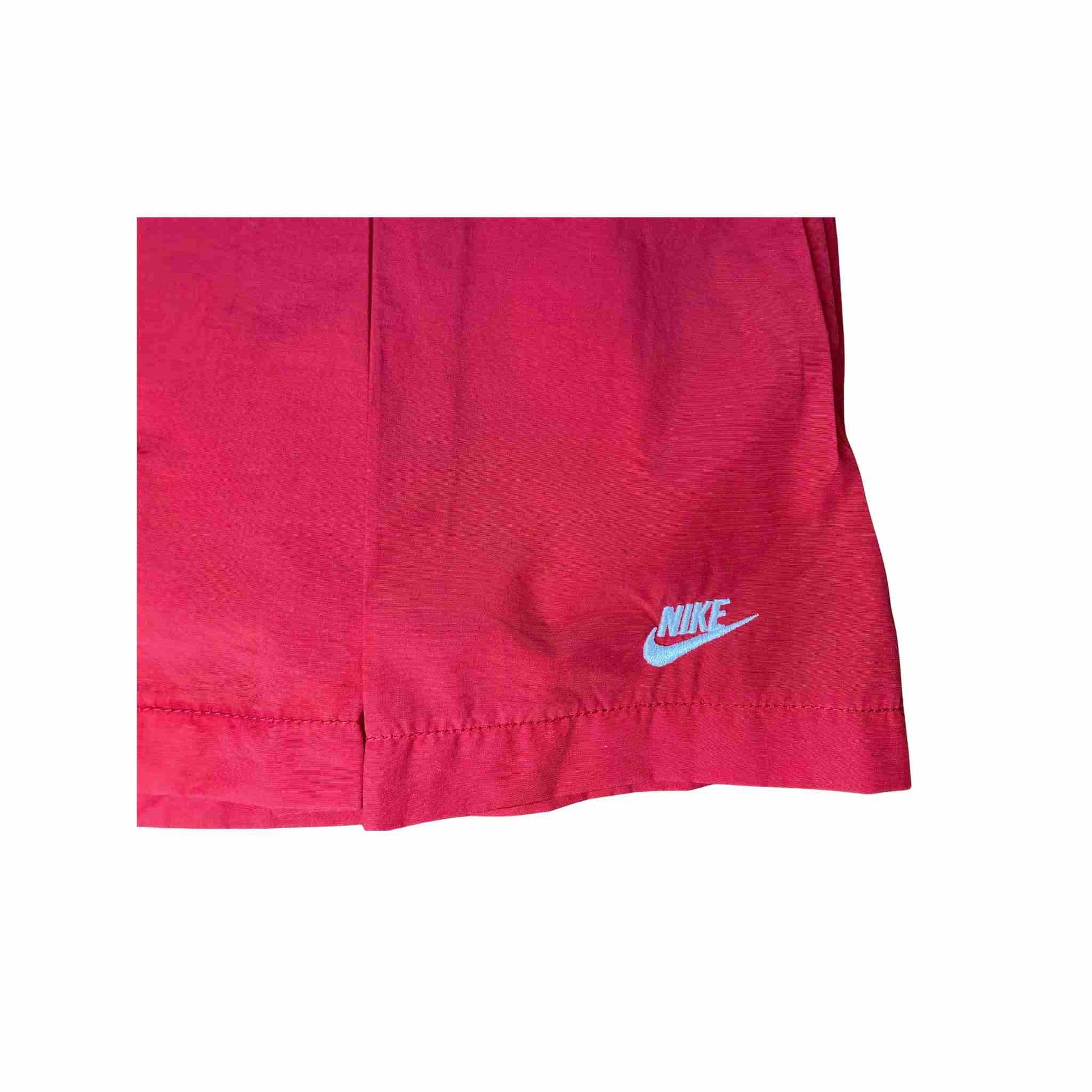 Close-up of a red Nike tennis skirt on a white background