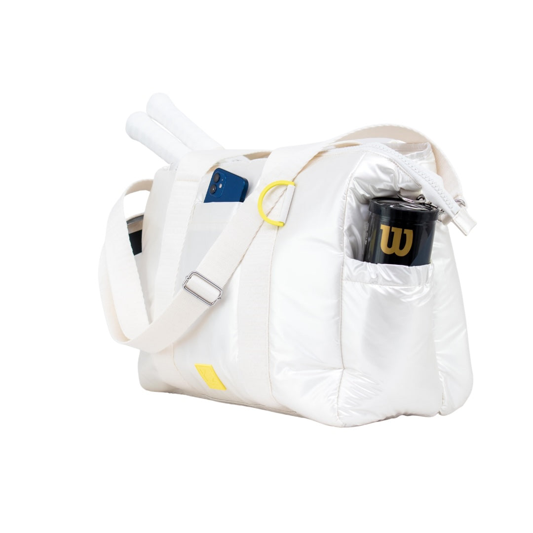 White duffel bag with tennis racket and Wilson branded item on a white background