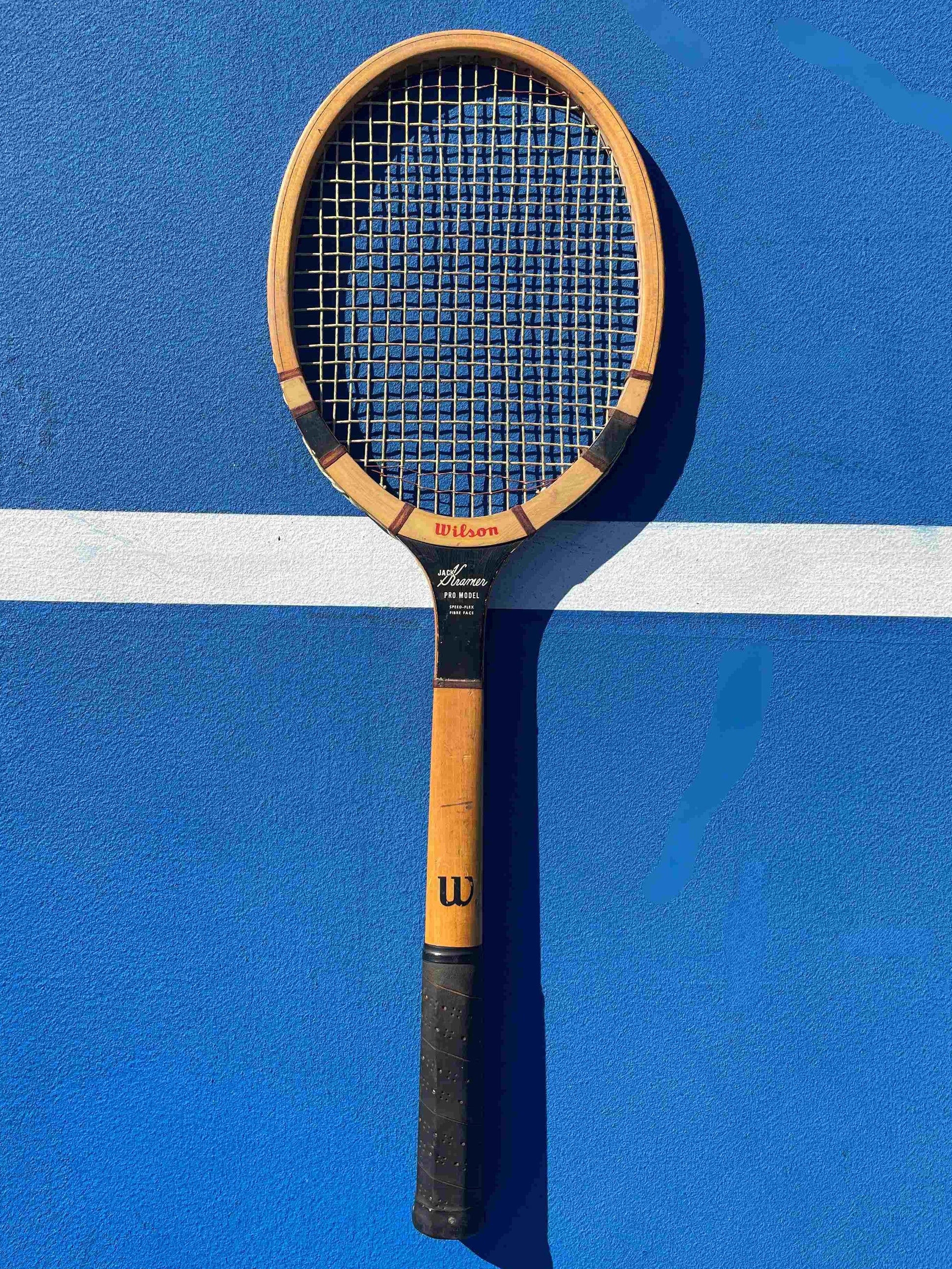 Vintage Jack Kramer WilsonTennis racket on a blue court with a white line