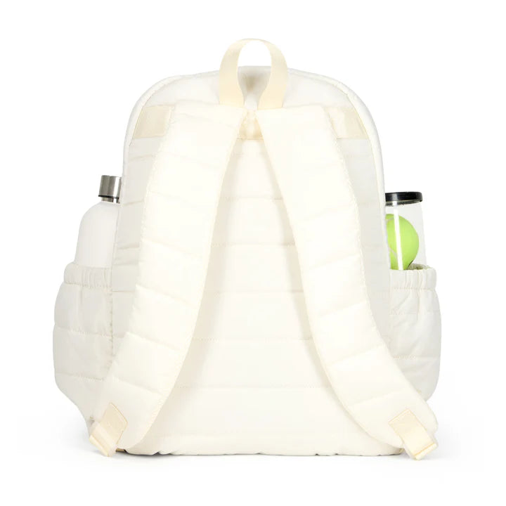 White quilted tennis backpack with a water bottle and snack container on a white background