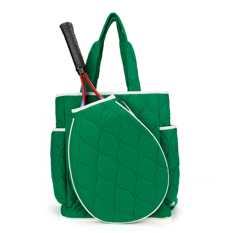 Green quilted tennis tote bag with a tennis racket and racket cover on a white background