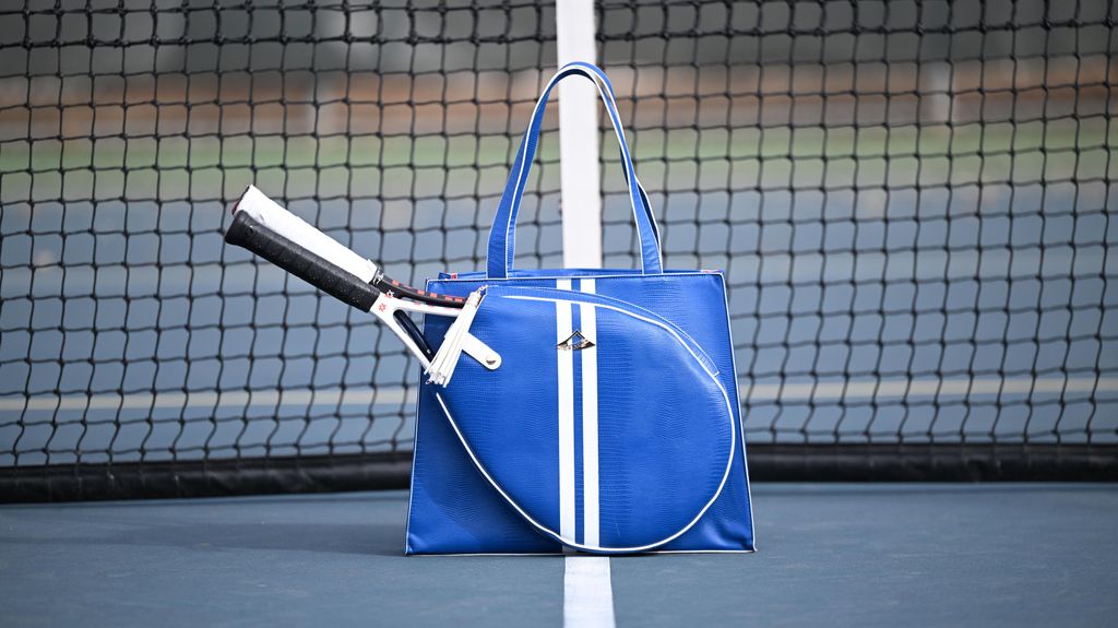 Blue tennis  handbag with a tennis racket on a tennis court