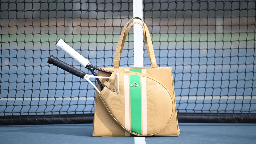 Beige tennis  handbag with green stripe on a tennis court