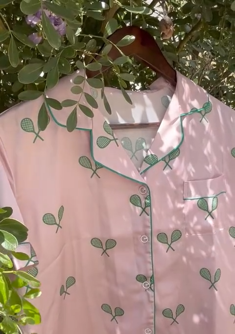 Pink satin pajamas with green tennis racquets on Tennis DuJour.