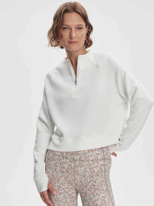 Model wearing Varley Ebba Halfzip MidLayer top in Snow White on TennisDuJour.com.
